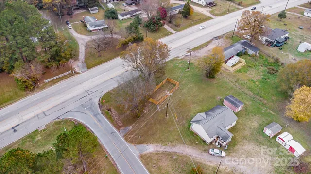an aerial view of a house a yard swimming pool and outdoor seating