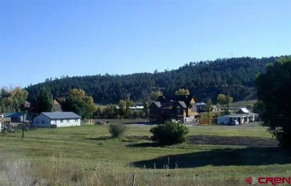 a view of a town with big trees