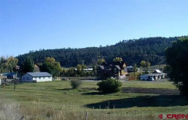a view of a town with big trees
