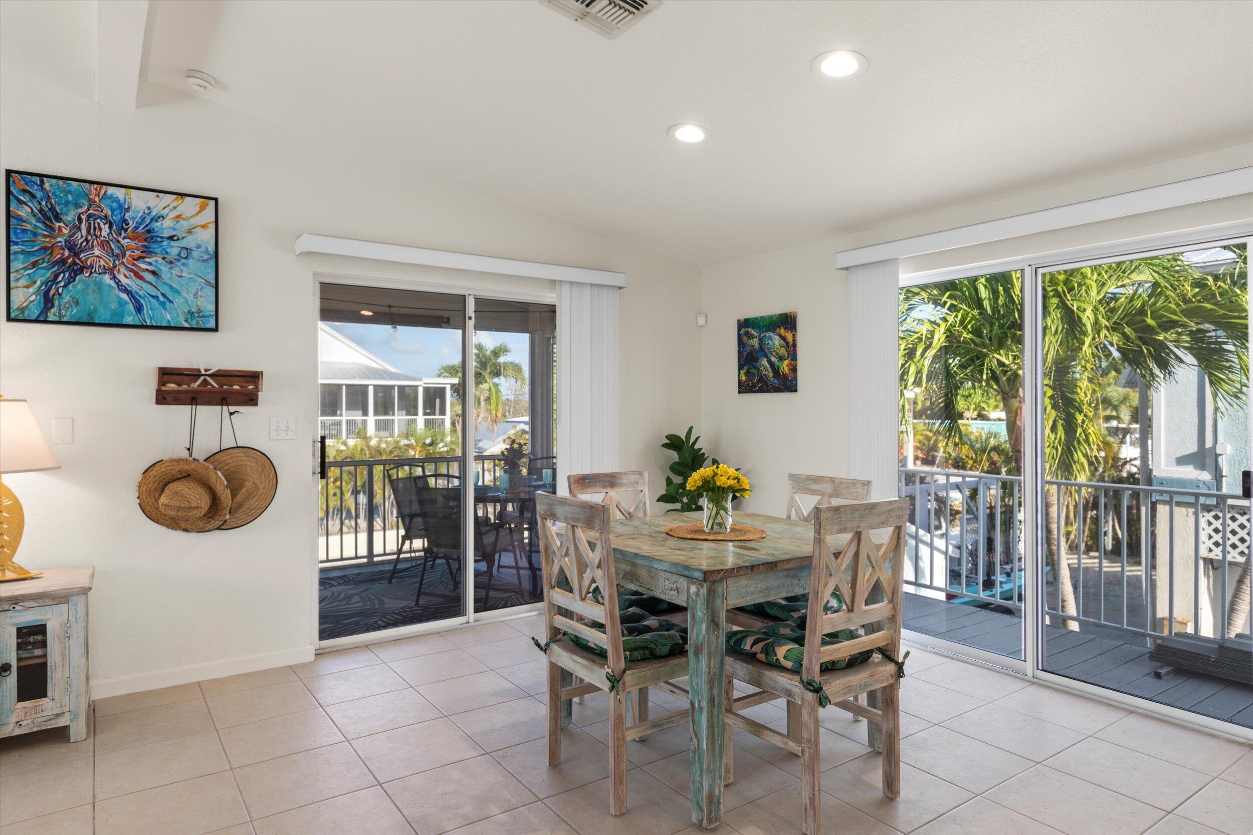 157 Mars Lane Key West, FL 33040 - Photo 12 of 41 a view of a dining room and kitchen with furniture and large window