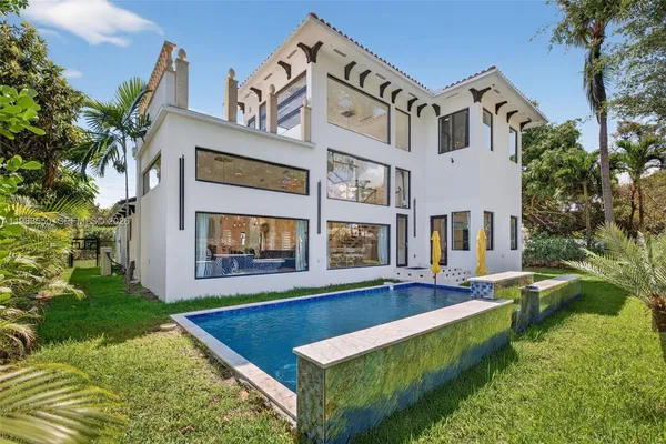 a front view of a house with a yard and pathway