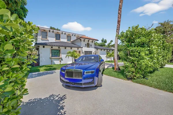 a kitchen with stainless steel appliances kitchen island granite countertop a stove a sink a refrigerator and a wooden floor