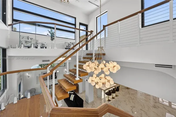 an aerial view of a house with a yard and lake view