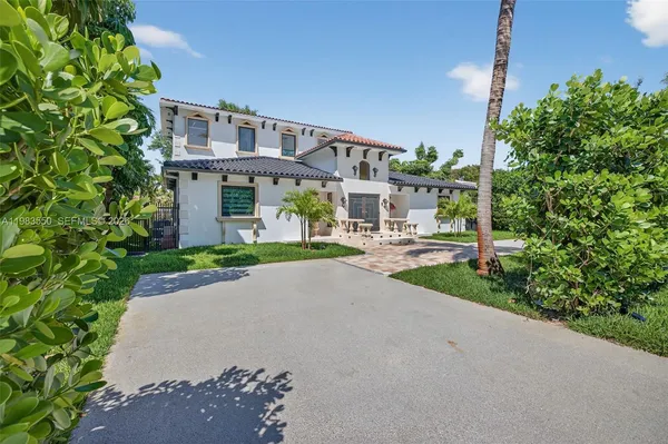 a large kitchen with stainless steel appliances granite countertop a sink and cabinets