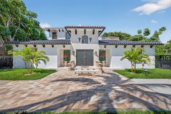 a kitchen with stainless steel appliances kitchen island granite countertop a refrigerator and a sink