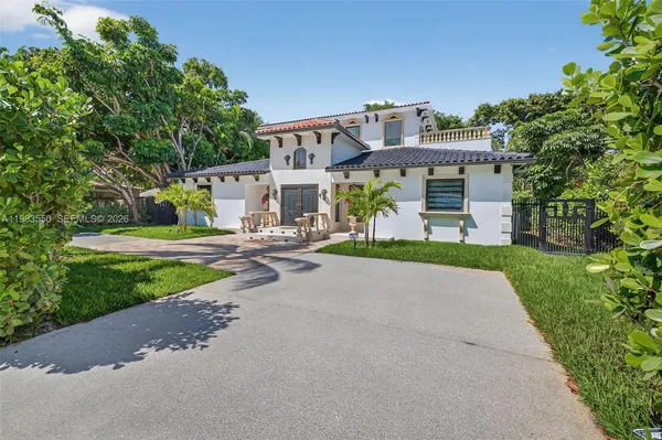 a kitchen with stainless steel appliances granite countertop a refrigerator sink and white cabinets