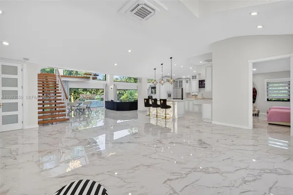 a kitchen with stainless steel appliances granite countertop a sink a stove and a wooden floors