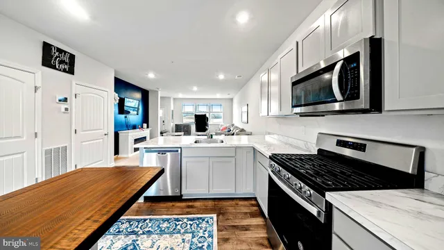 a kitchen with a stove a sink and a microwave