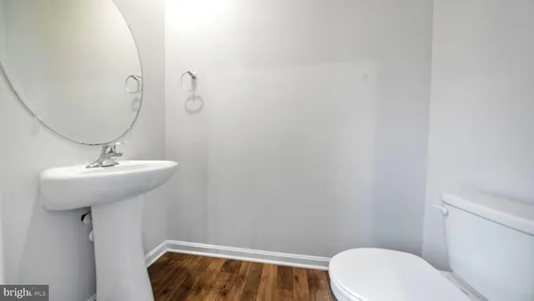 a bathroom with a sink a toilet and mirror