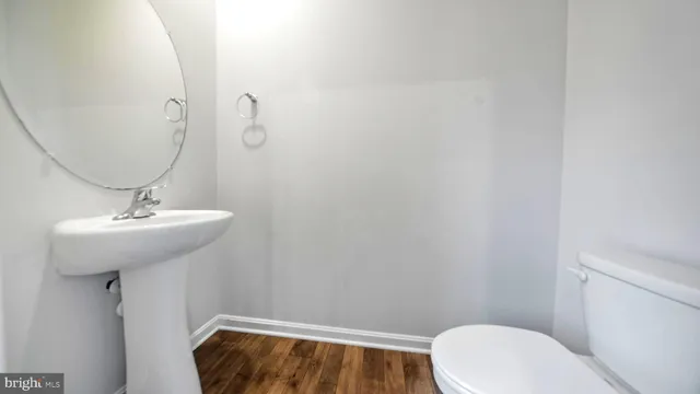 a bathroom with a sink a toilet and mirror