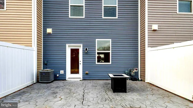 a view of a brick house with wooden stairs