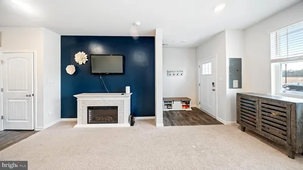 a view of an empty room with window and fire place
