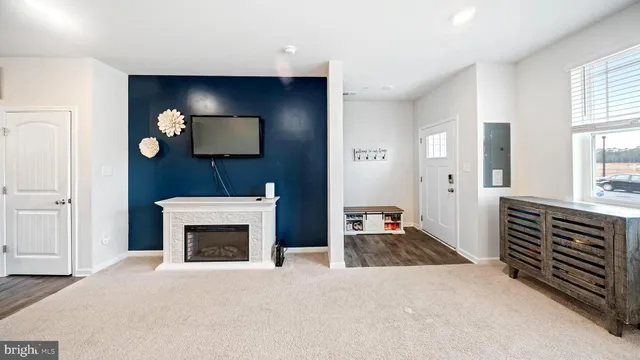 a view of an empty room with window and fire place