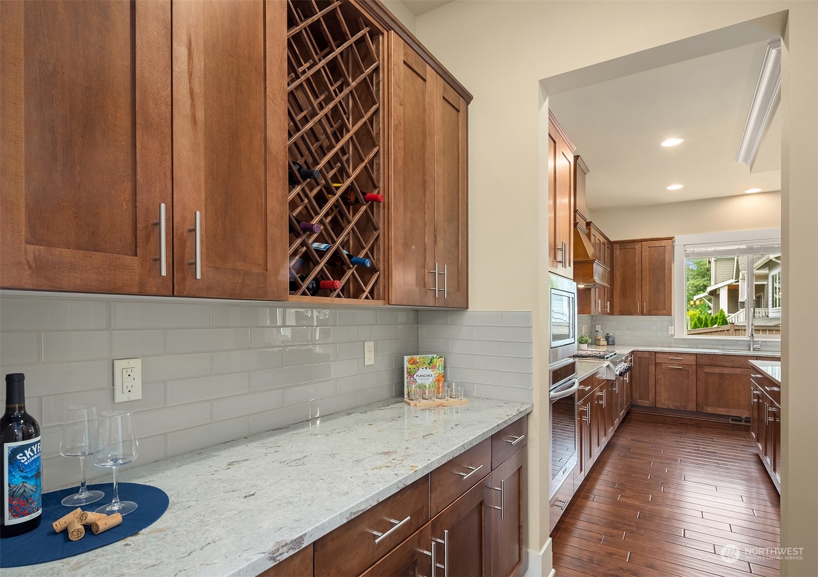 13949 174th Terrace Southeast Renton, WA 98059 - Photo 11 of 38 a kitchen with lots of counter top space and wooden floor