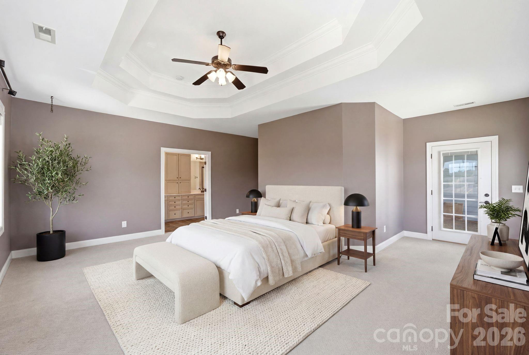 10227 Sam Meeks Road Pineville, NC 28134 - Photo 15 of 27 a bedroom with a large bed and a chandelier