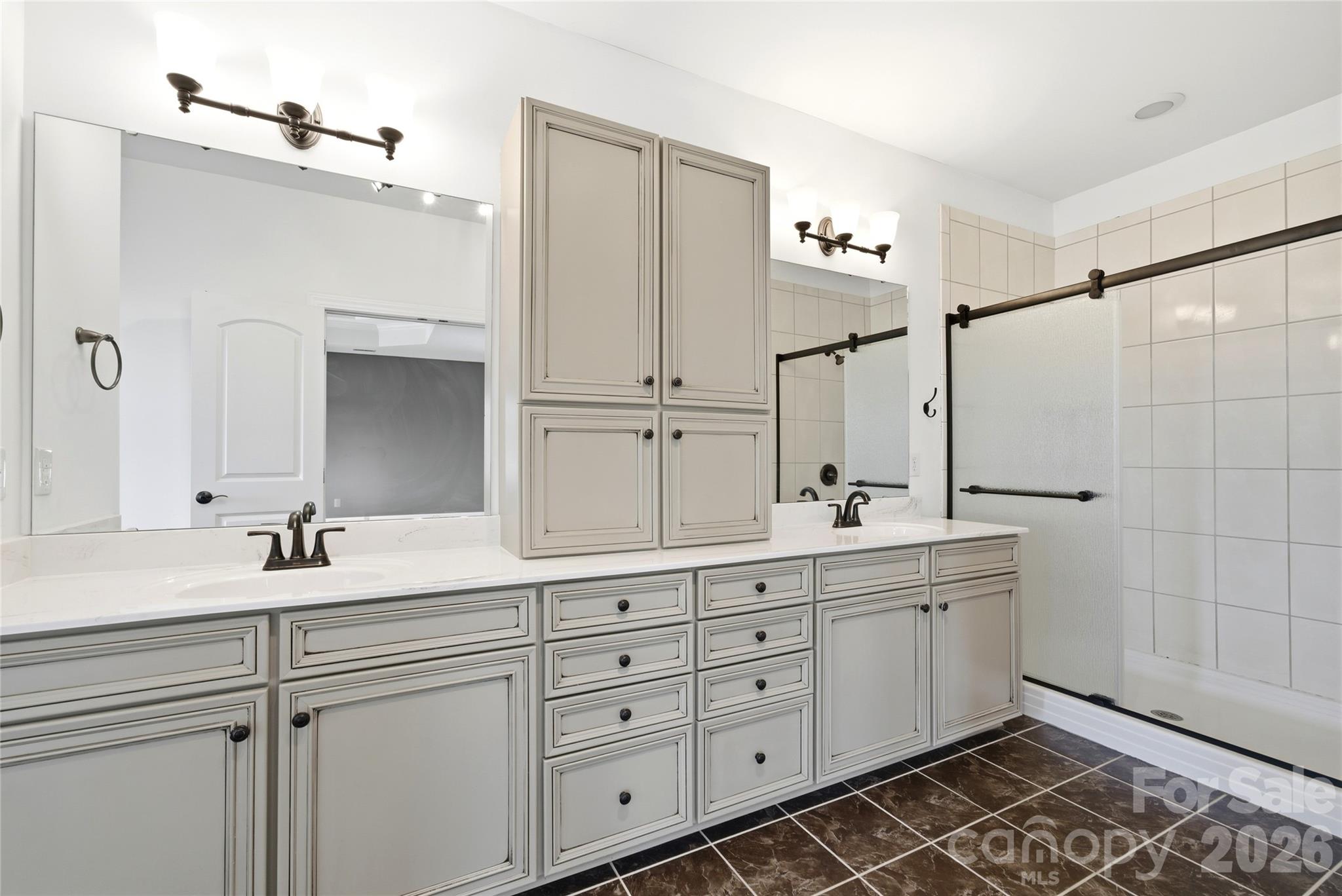 10227 Sam Meeks Road Pineville, NC 28134 - Photo 18 of 27 a bathroom with a double vanity sink and mirror