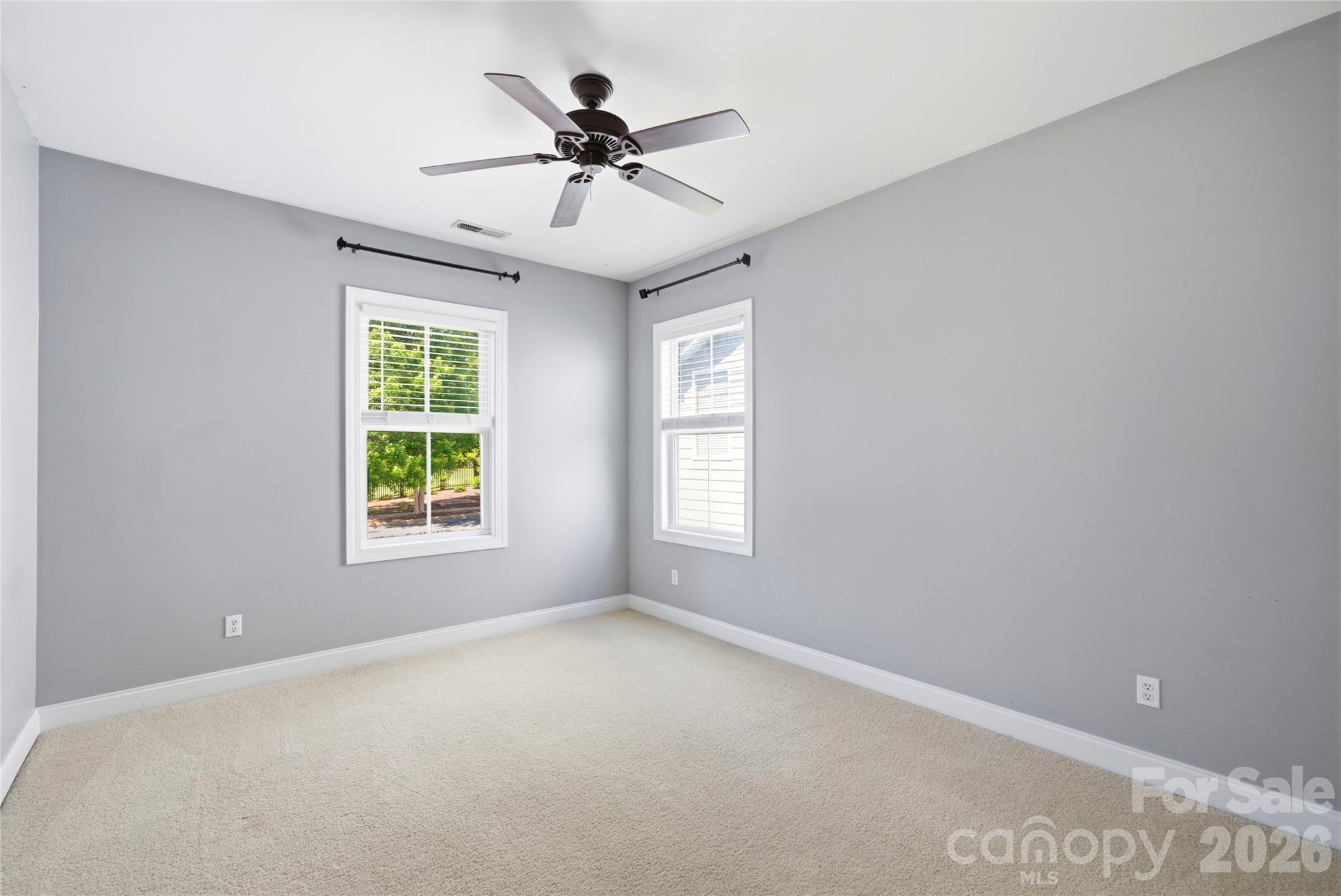 10227 Sam Meeks Road Pineville, NC 28134 - Photo 19 of 27 a view of a big room with windows and chandelier fan
