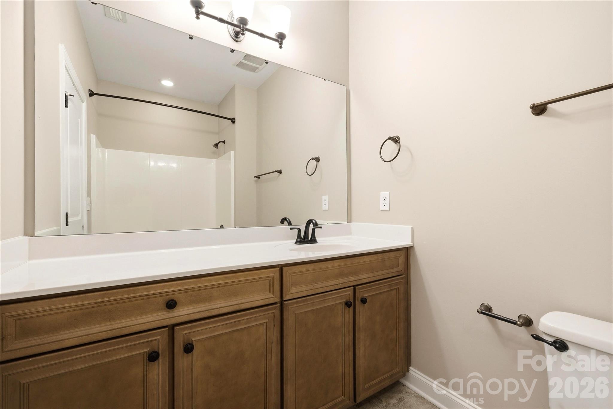 10227 Sam Meeks Road Pineville, NC 28134 - Photo 23 of 27 a bathroom with a sink and a mirror