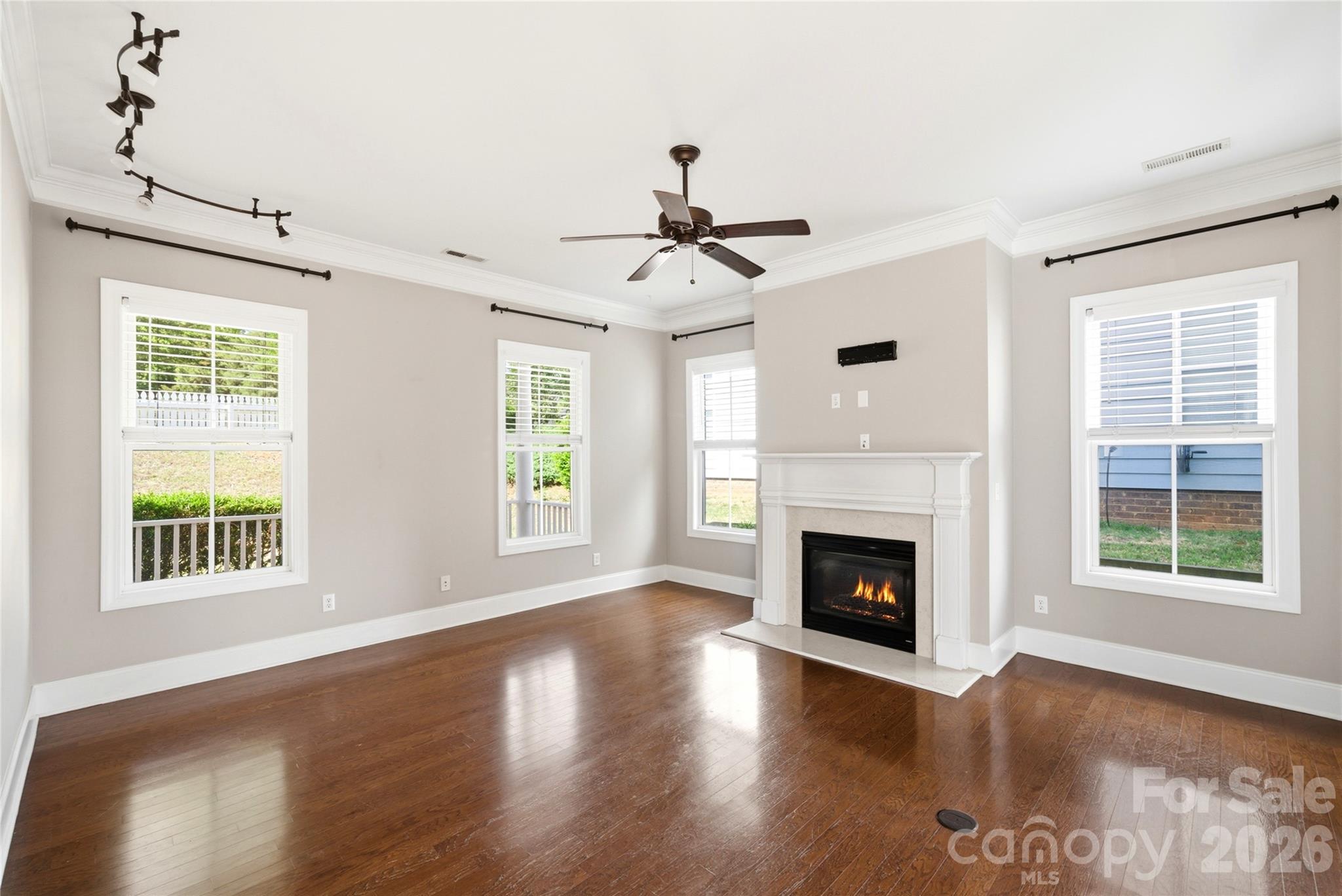 10227 Sam Meeks Road Pineville, NC 28134 - Photo 3 of 27 a living room with a fireplace and wooden floor