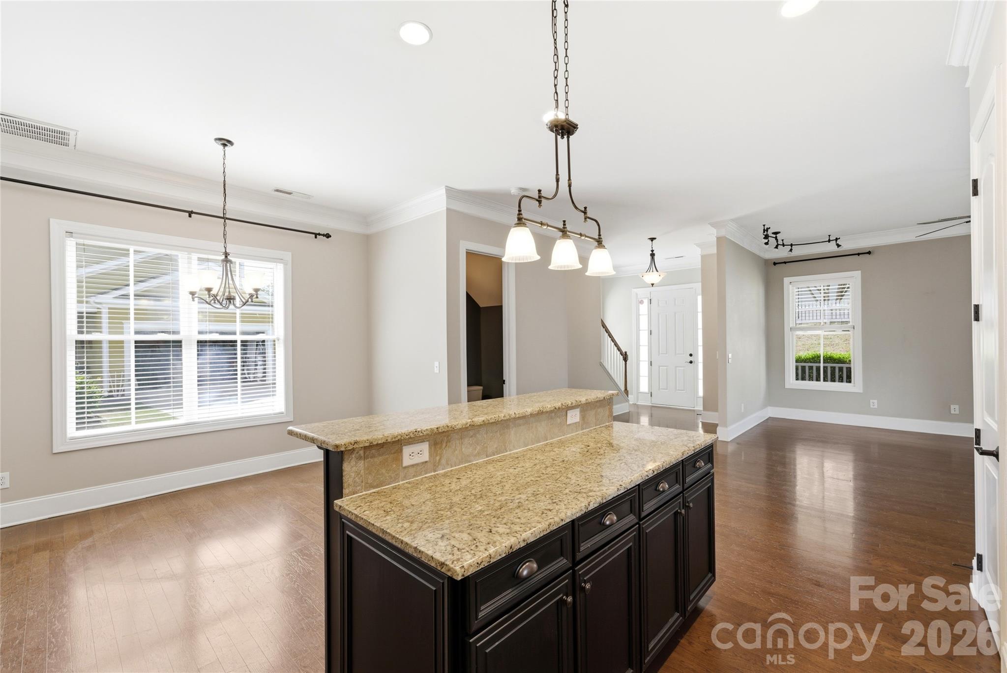 10227 Sam Meeks Road Pineville, NC 28134 - Photo 8 of 27 a kitchen with stainless steel appliances granite countertop a sink a stove and a wooden floor