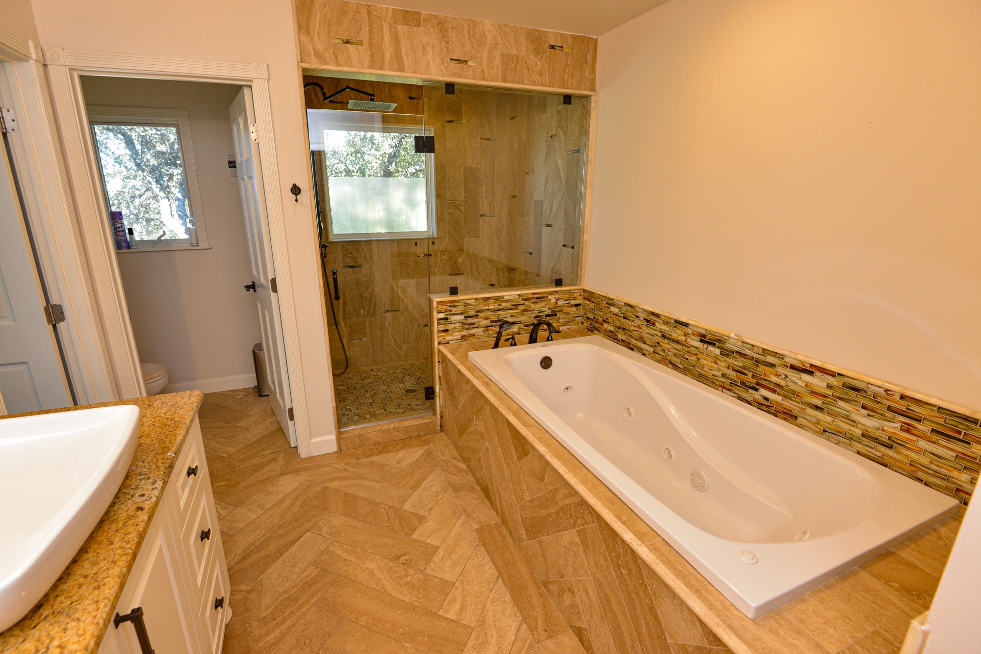 10710 D-K Ranch Road Austin, TX 78759 - Photo 20 of 34 Elegant primary bath featuring a luxurious soaking tub, a tiled walk-in shower, and stylish granite counters.