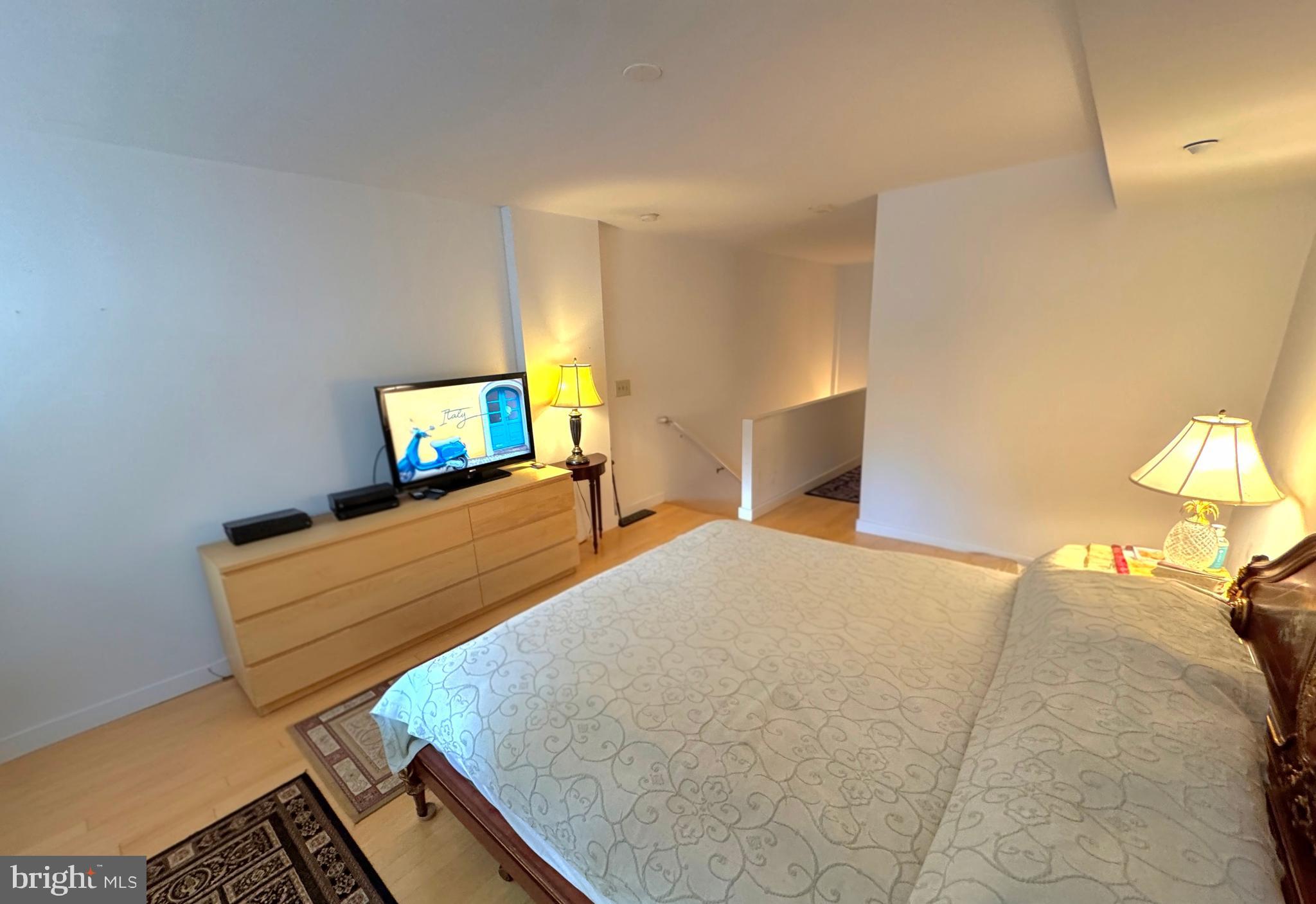 912 F Street Northwest, Unit 703 Washington, DC 20004 - Photo 18 of 52 a bedroom with a bed and a flat screen tv
