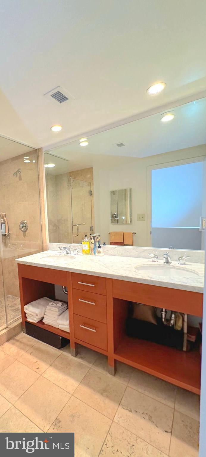 912 F Street Northwest, Unit 703 Washington, DC 20004 - Photo 20 of 52 a bathroom with a sink and a mirror