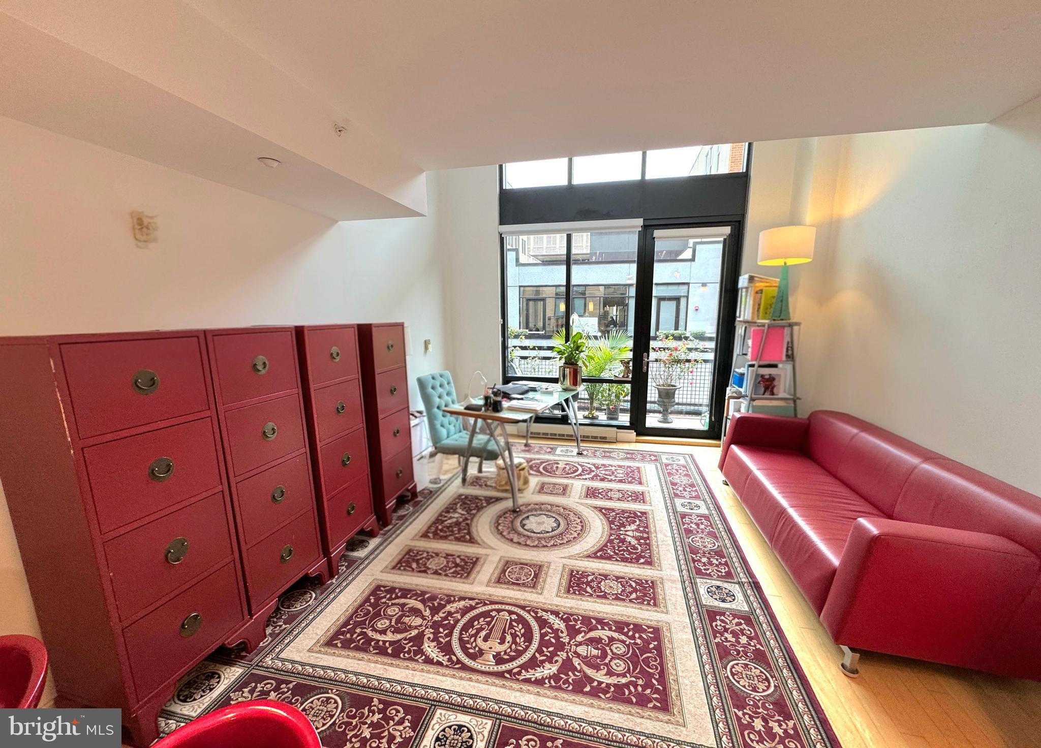 912 F Street Northwest, Unit 703 Washington, DC 20004 - Photo 2 of 56 a living room with furniture and a rug