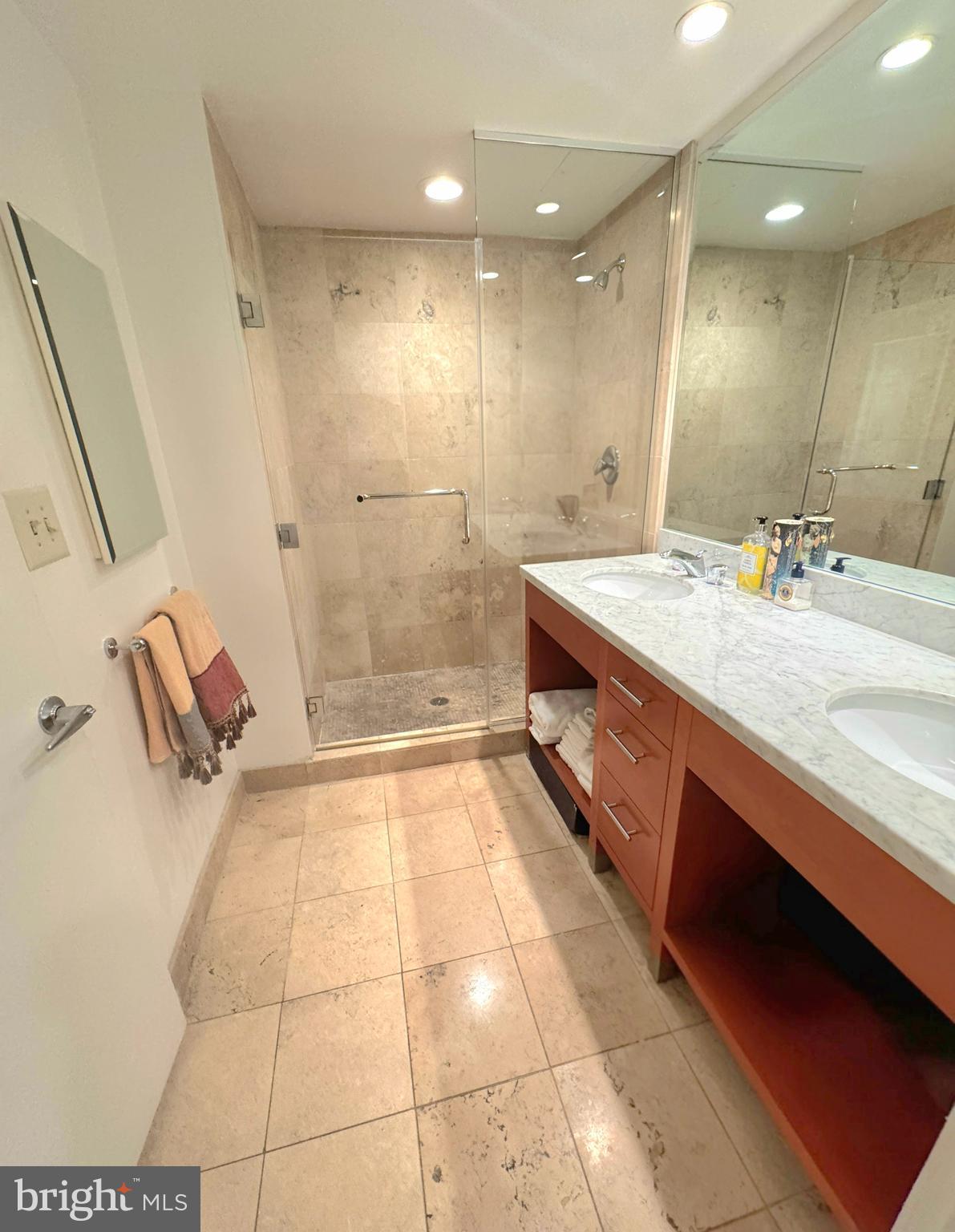 912 F Street Northwest, Unit 703 Washington, DC 20004 - Photo 22 of 56 a spacious bathroom with a granite countertop sink a toilet and a mirror