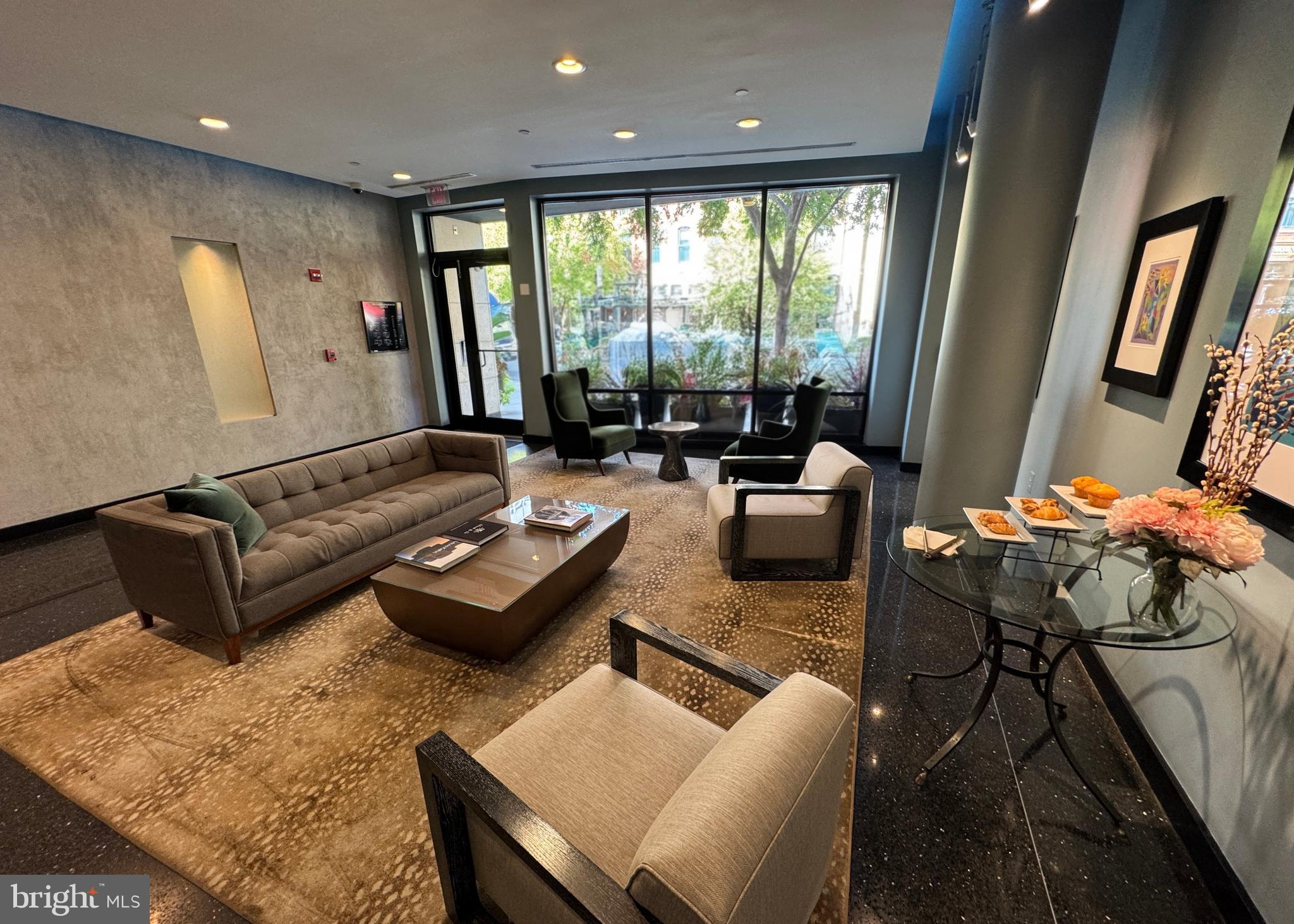 912 F Street Northwest, Unit 703 Washington, DC 20004 - Photo 30 of 56 a living room with furniture and large windows