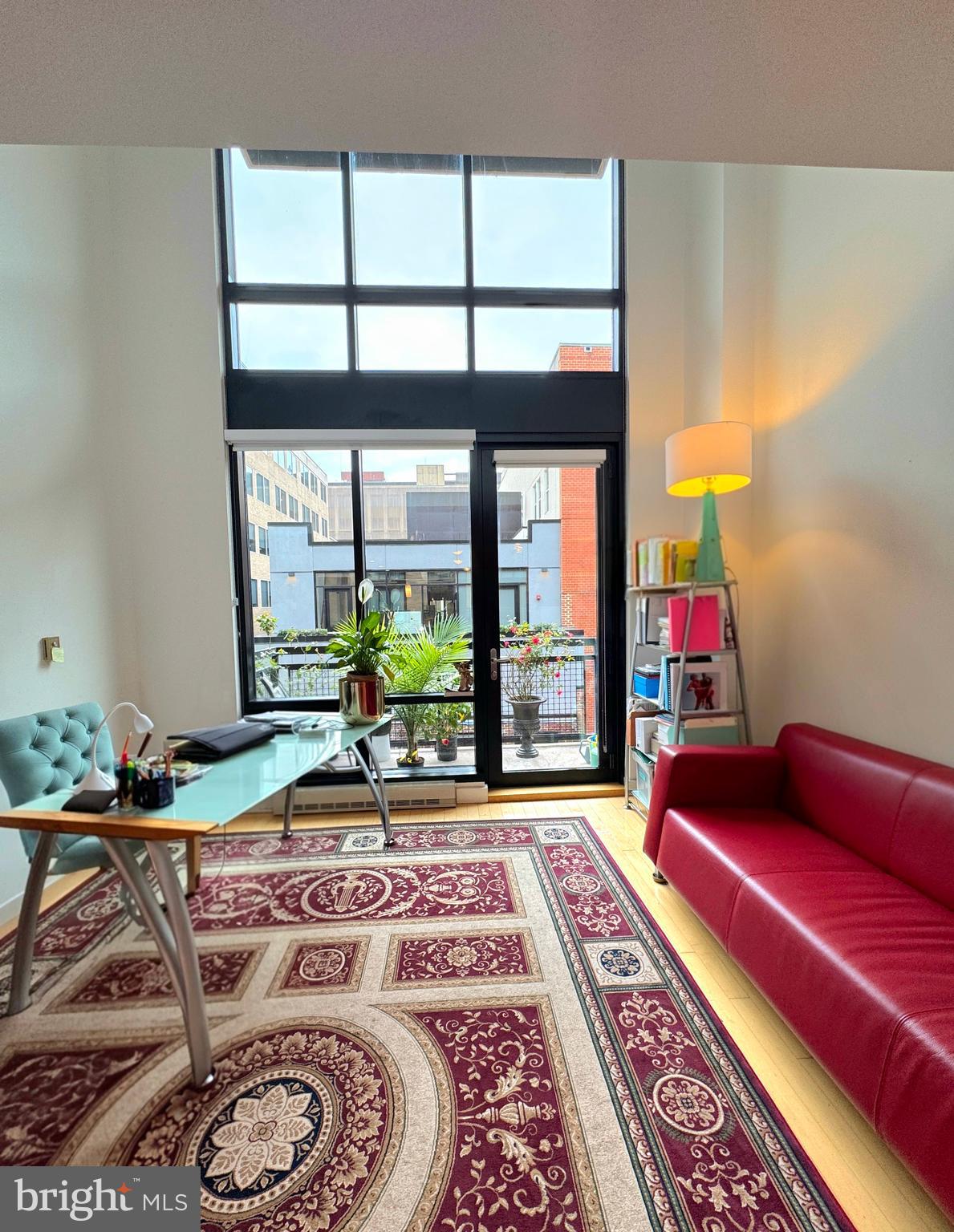 912 F Street Northwest, Unit 703 Washington, DC 20004 - Photo 7 of 52 a living room with furniture and a floor to ceiling window