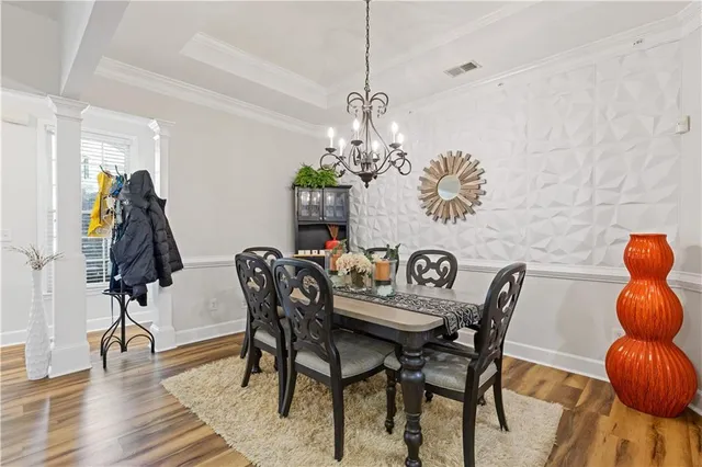 a view of a dining room with furniture and chandelier