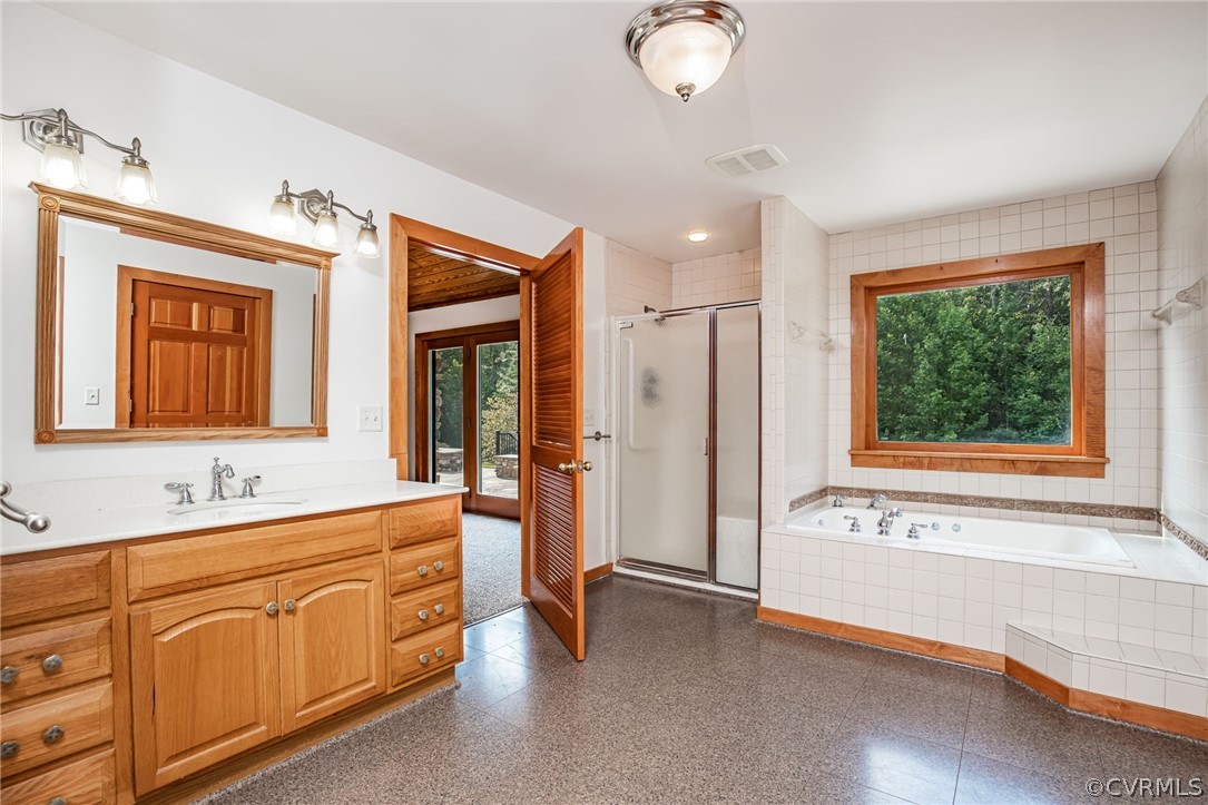 3409 Lowry Road Columbia, VA 23038 - Photo 14 of 37 a spacious bathroom with a granite countertop sink mirror and bathtub