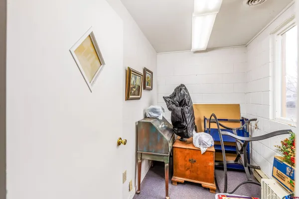 a room with gym equipment and wooden floor