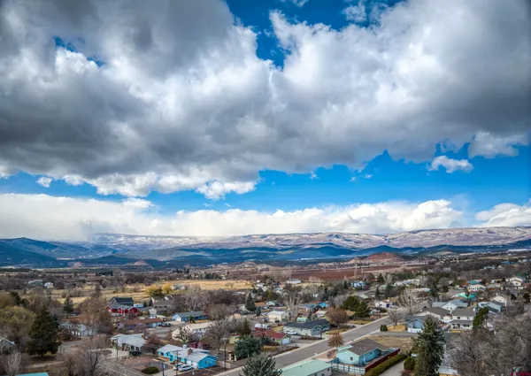 an aerial view of a residential houses with city view