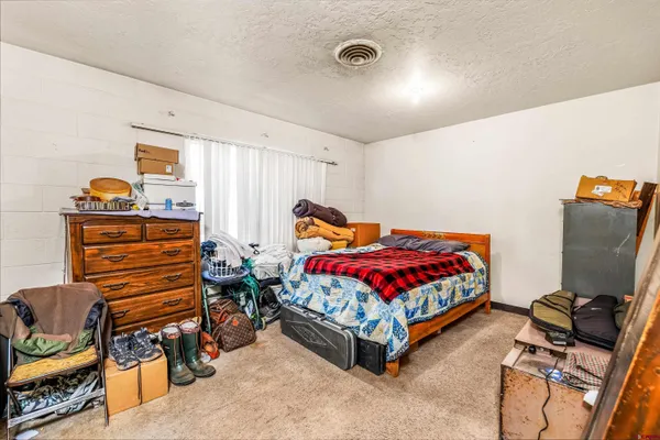 a bedroom with furniture and a flat screen tv
