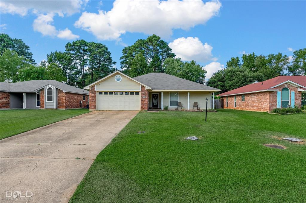 122 Ragan Lane Haughton, LA 71037 - Photo 24 of 34 Single-story residence featuring a covered front porch, an attached garage, and a concrete driveway