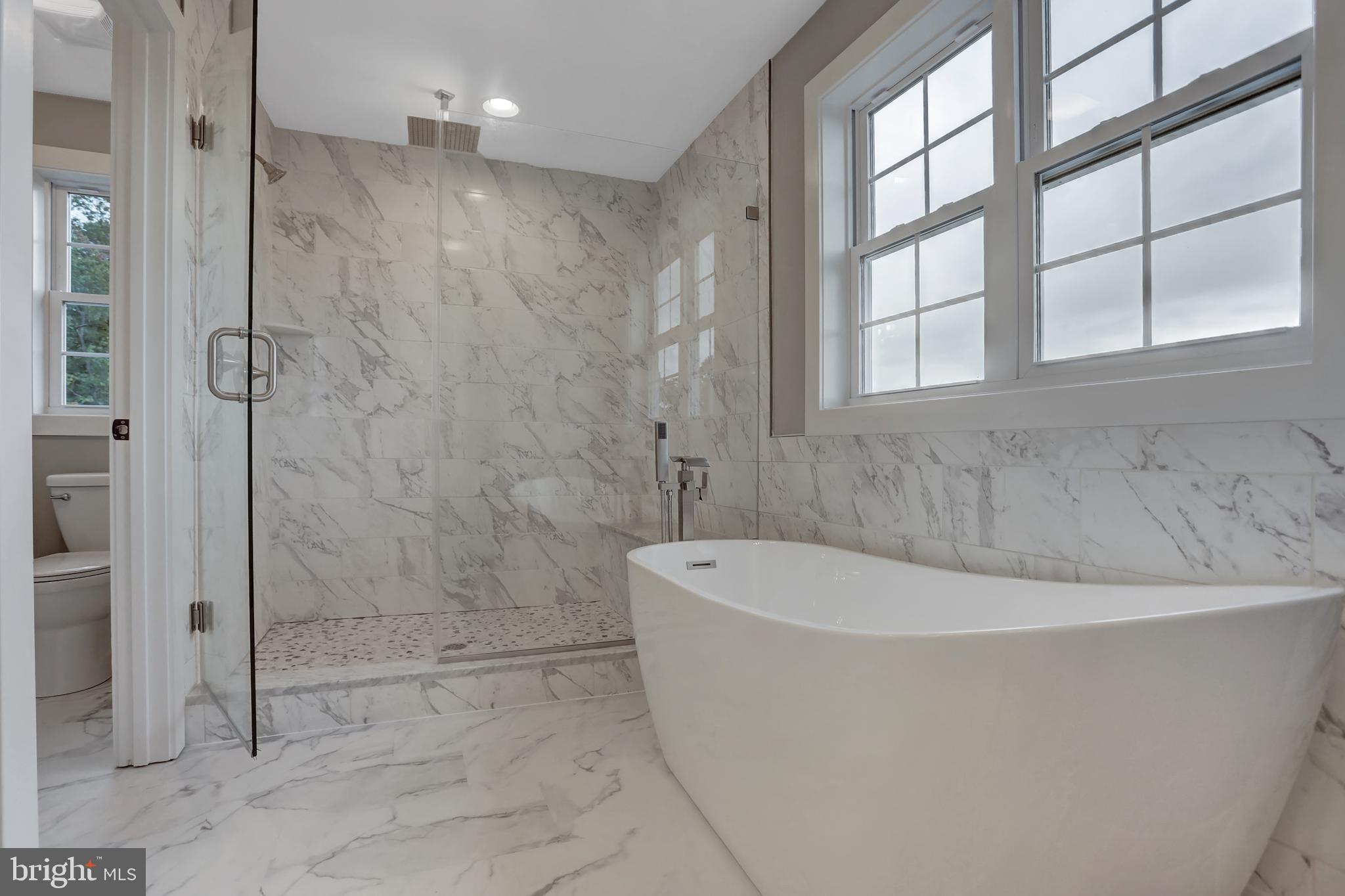 7319 Talbot Run Road Mount Airy, MD 21771 - Photo 33 of 54 Elegant tub & shower with marble tile surround