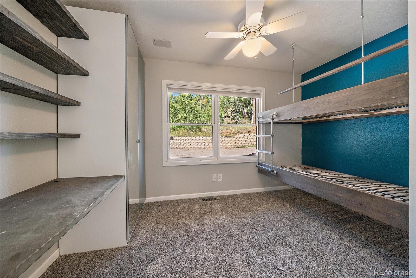 11842 South Geronimo Trail Conifer, CO 80433 - Photo 13 of 41 a view of room with window and ceiling fan