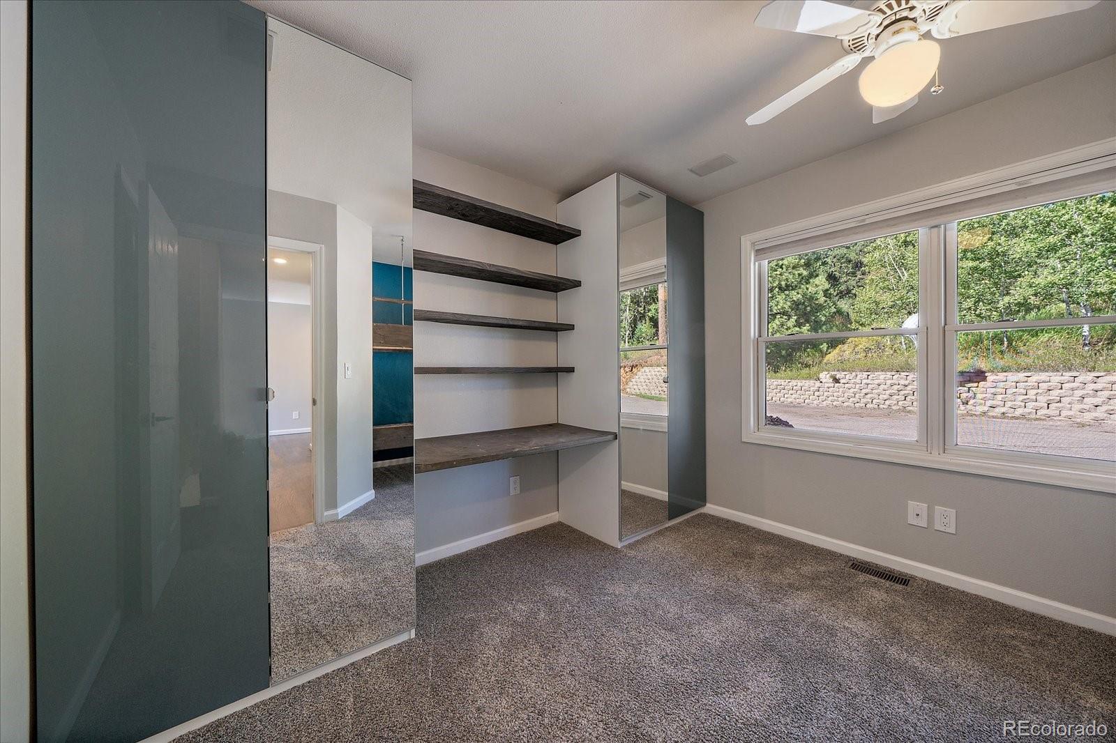 11842 South Geronimo Trail Conifer, CO 80433 - Photo 14 of 41 a view of room with window and ceiling fan
