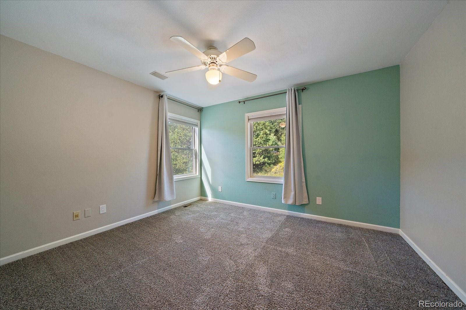 11842 South Geronimo Trail Conifer, CO 80433 - Photo 24 of 41 an empty room with windows and fan