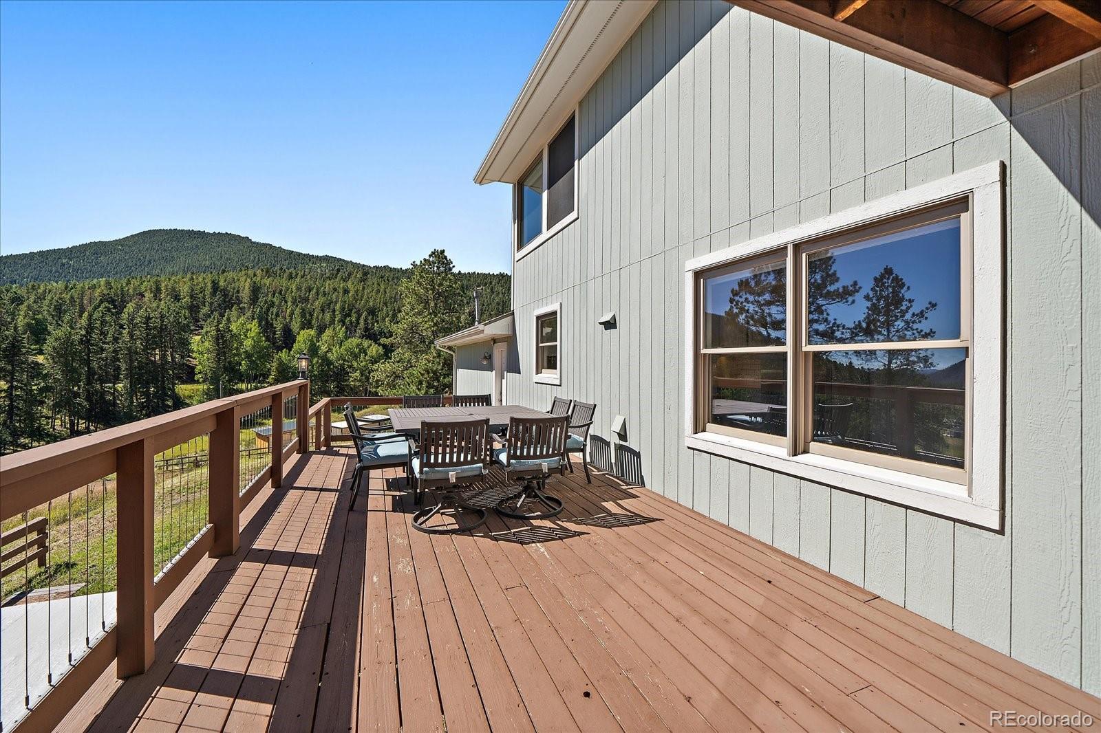 11842 South Geronimo Trail Conifer, CO 80433 - Photo 30 of 41 a balcony with wooden floor and outdoor seating