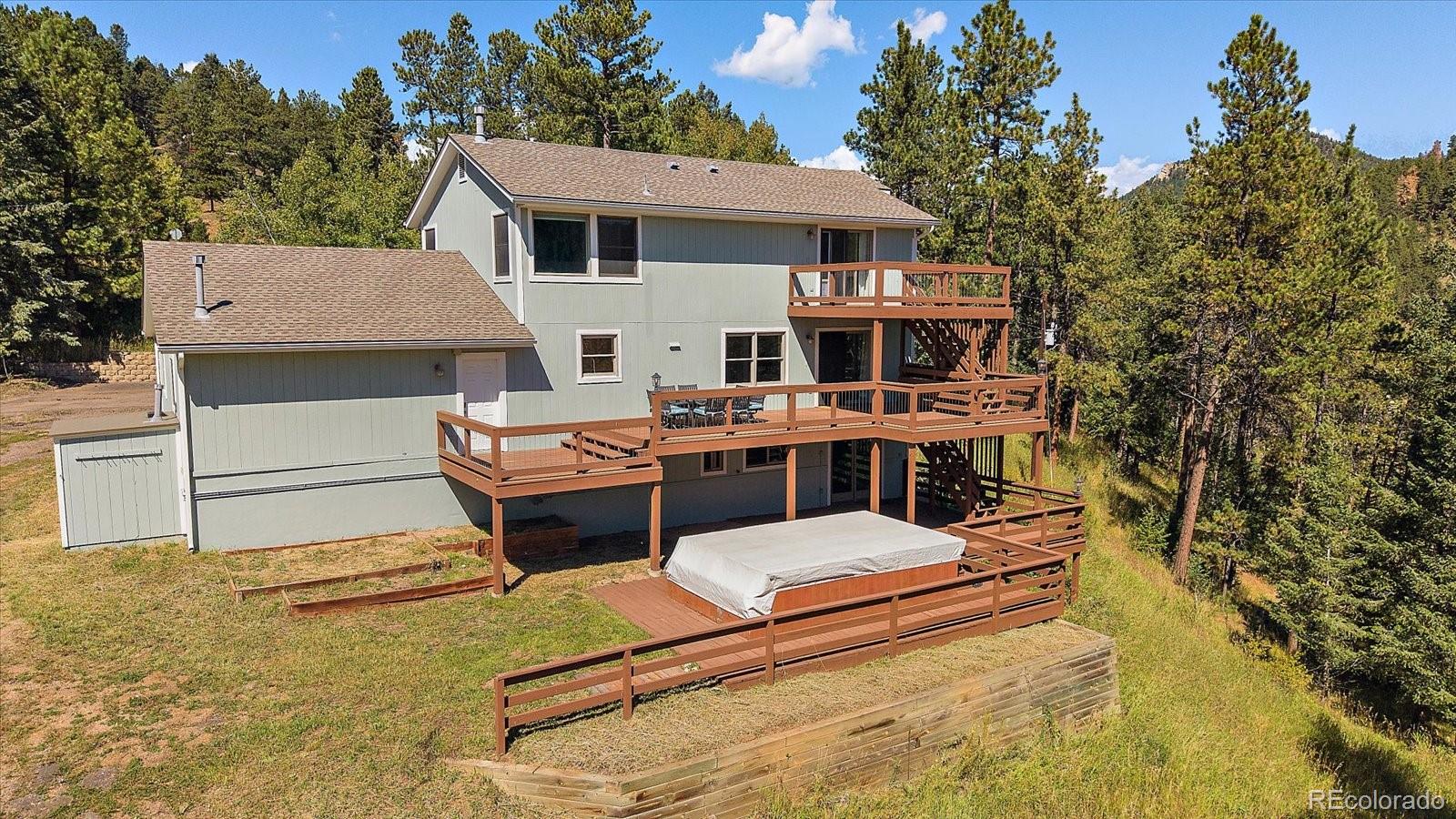 11842 South Geronimo Trail Conifer, CO 80433 - Photo 32 of 41 a house view with a garden space