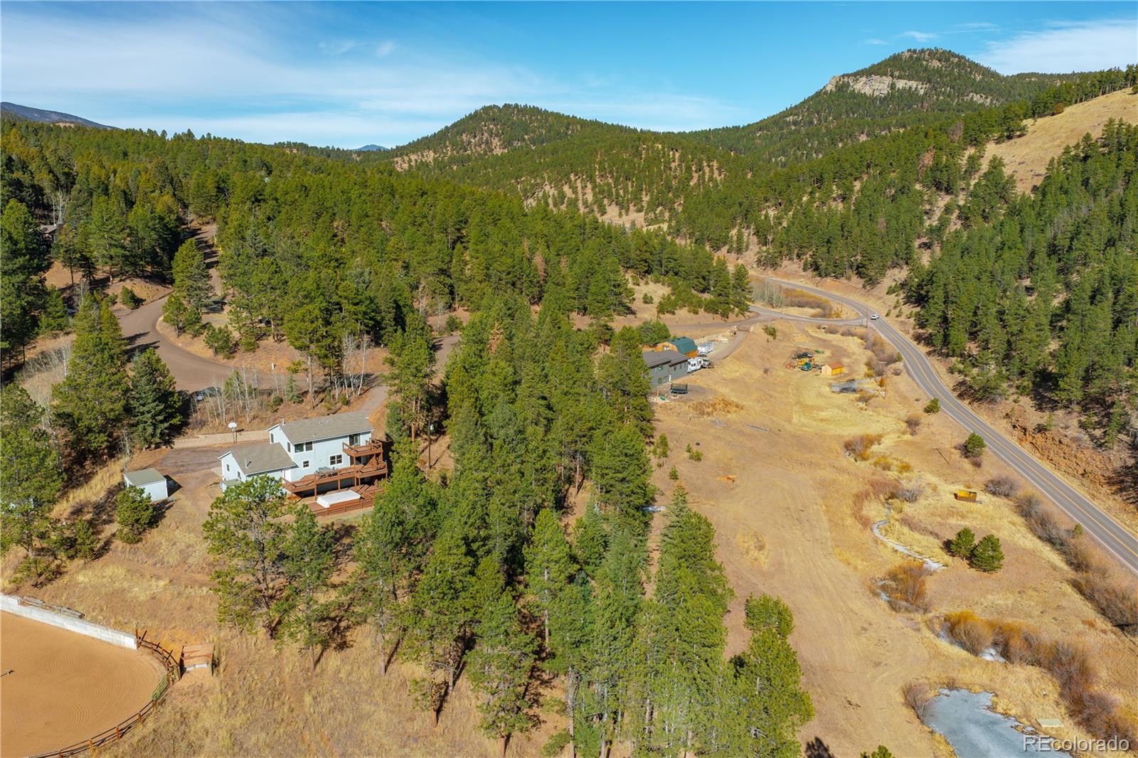 11842 South Geronimo Trail Conifer, CO 80433 - Photo 40 of 41 a view of a lush green hillside and houses