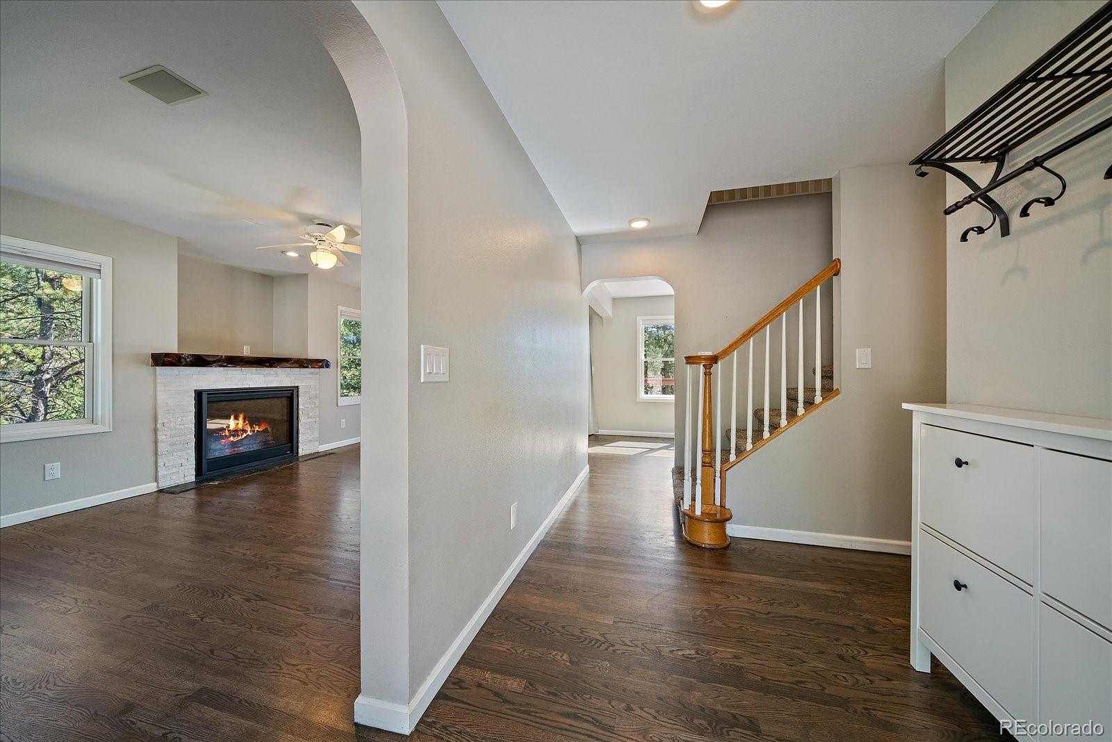 11842 South Geronimo Trail Conifer, CO 80433 - Photo 6 of 41 a view of a hallway with wooden floor and staircase