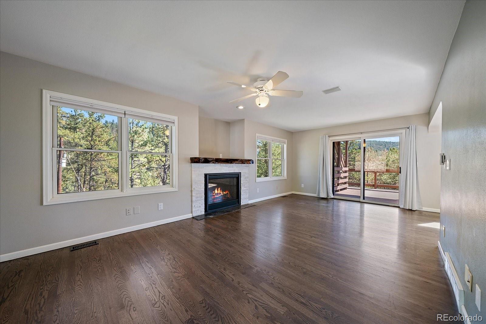 11842 South Geronimo Trail Conifer, CO 80433 - Photo 8 of 41 a view of an empty room with wooden floor and a window