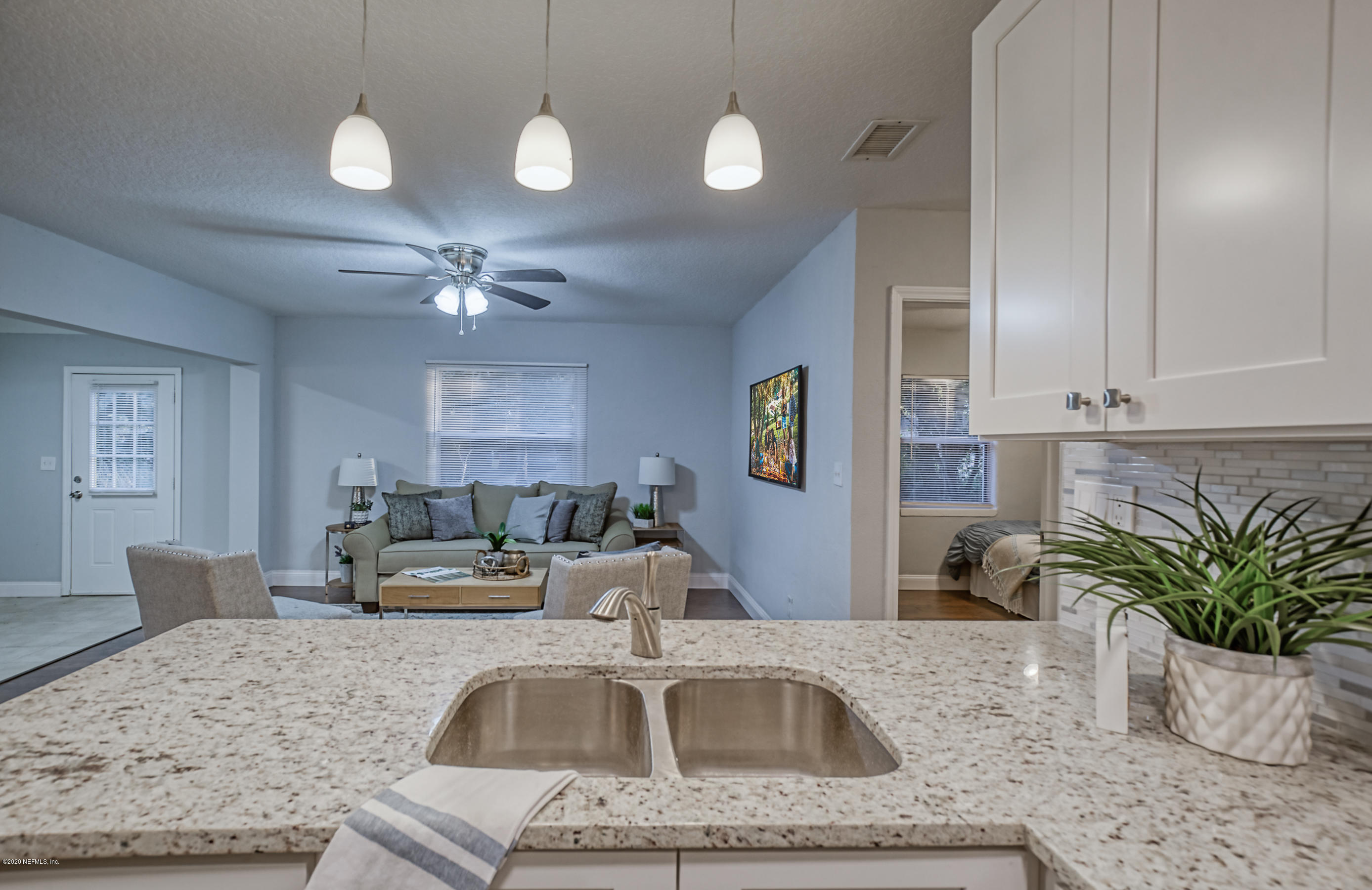 6711 Ryance Road Jacksonville, FL 32211 - Photo 14 of 26 a kitchen with a sink a counter space and cabinets
