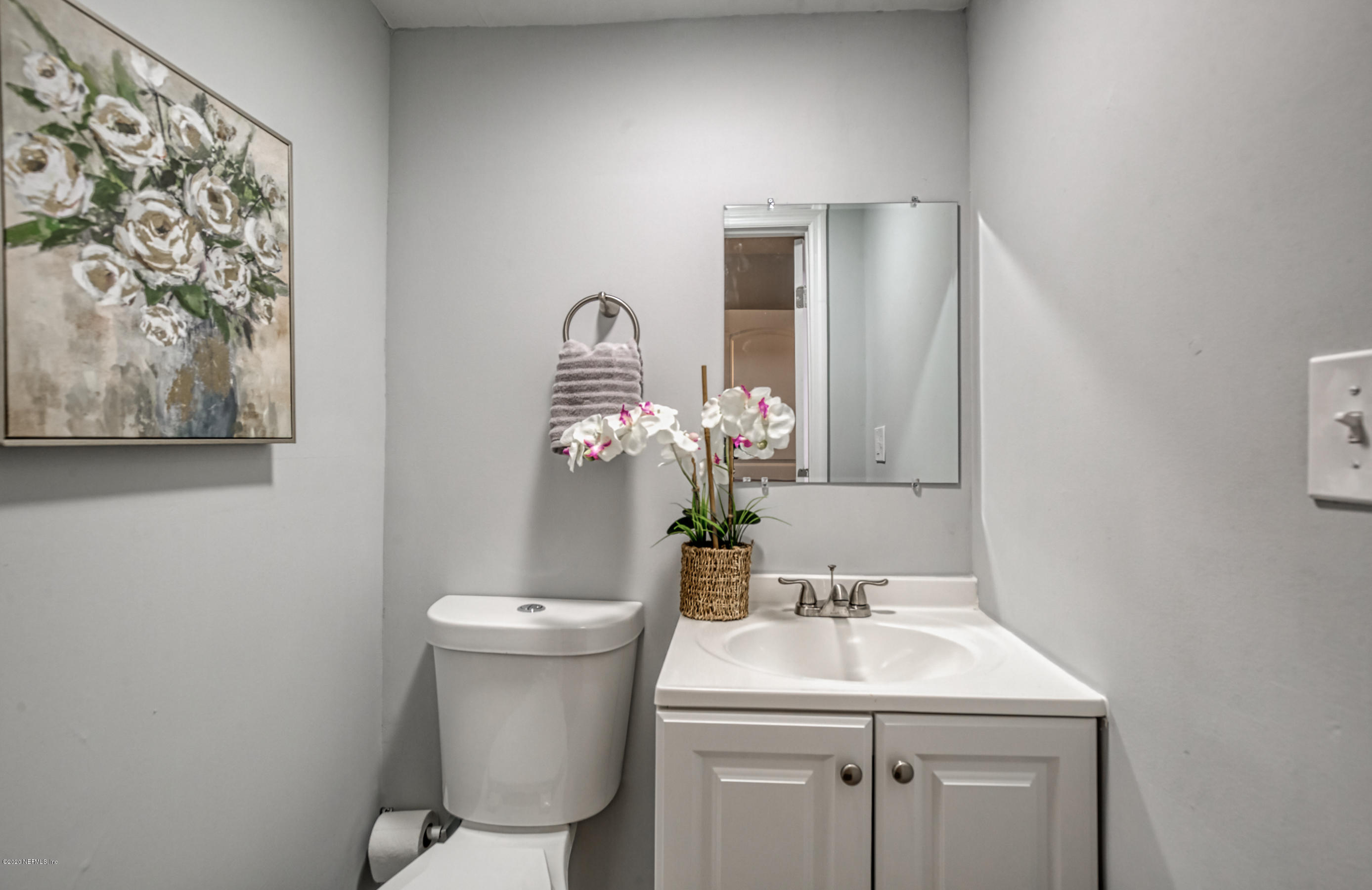 6711 Ryance Road Jacksonville, FL 32211 - Photo 21 of 26 a bathroom with a toilet sink and mirror