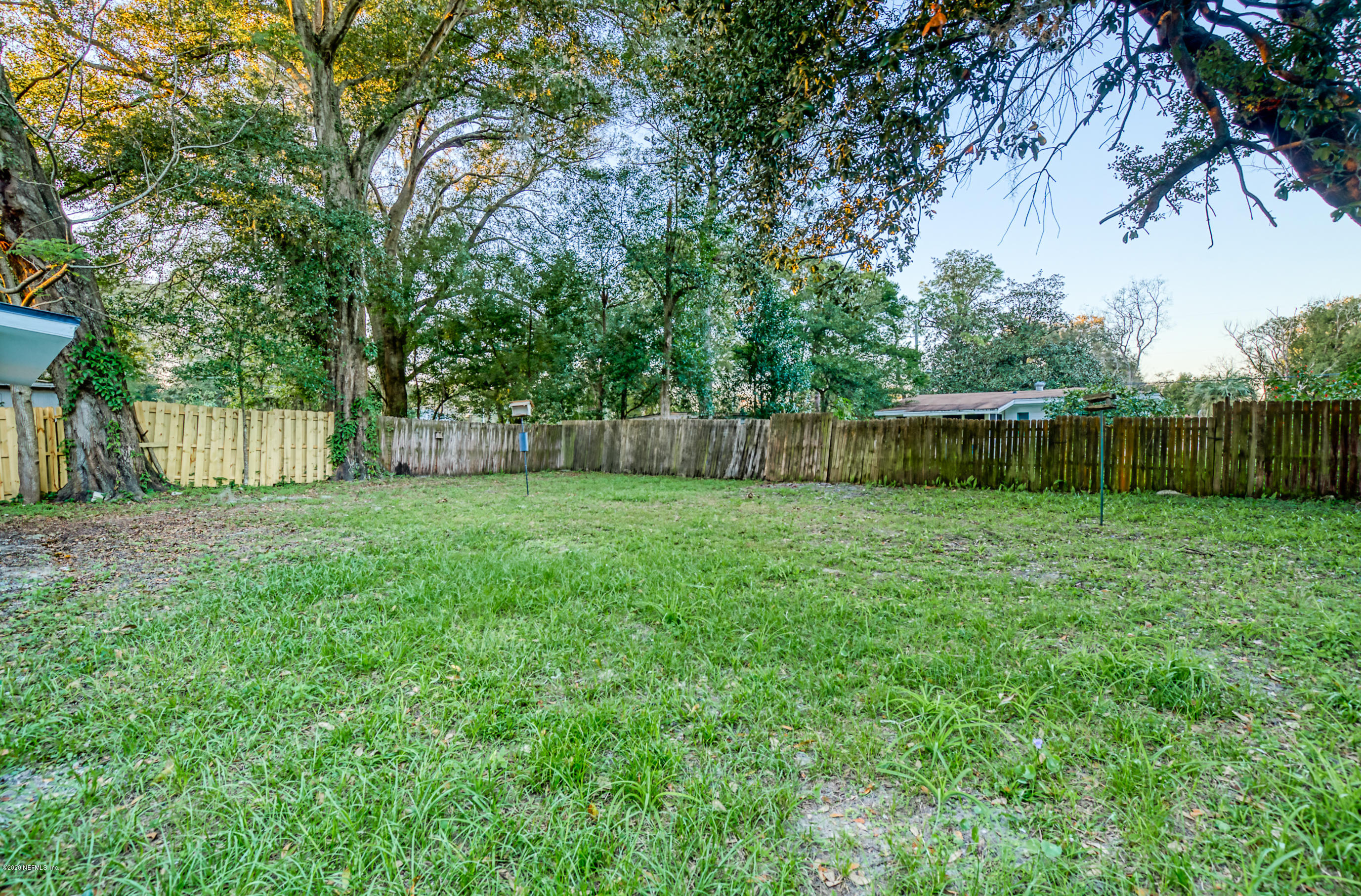 6711 Ryance Road Jacksonville, FL 32211 - Photo 24 of 26 a view of a backyard with a garden and trees