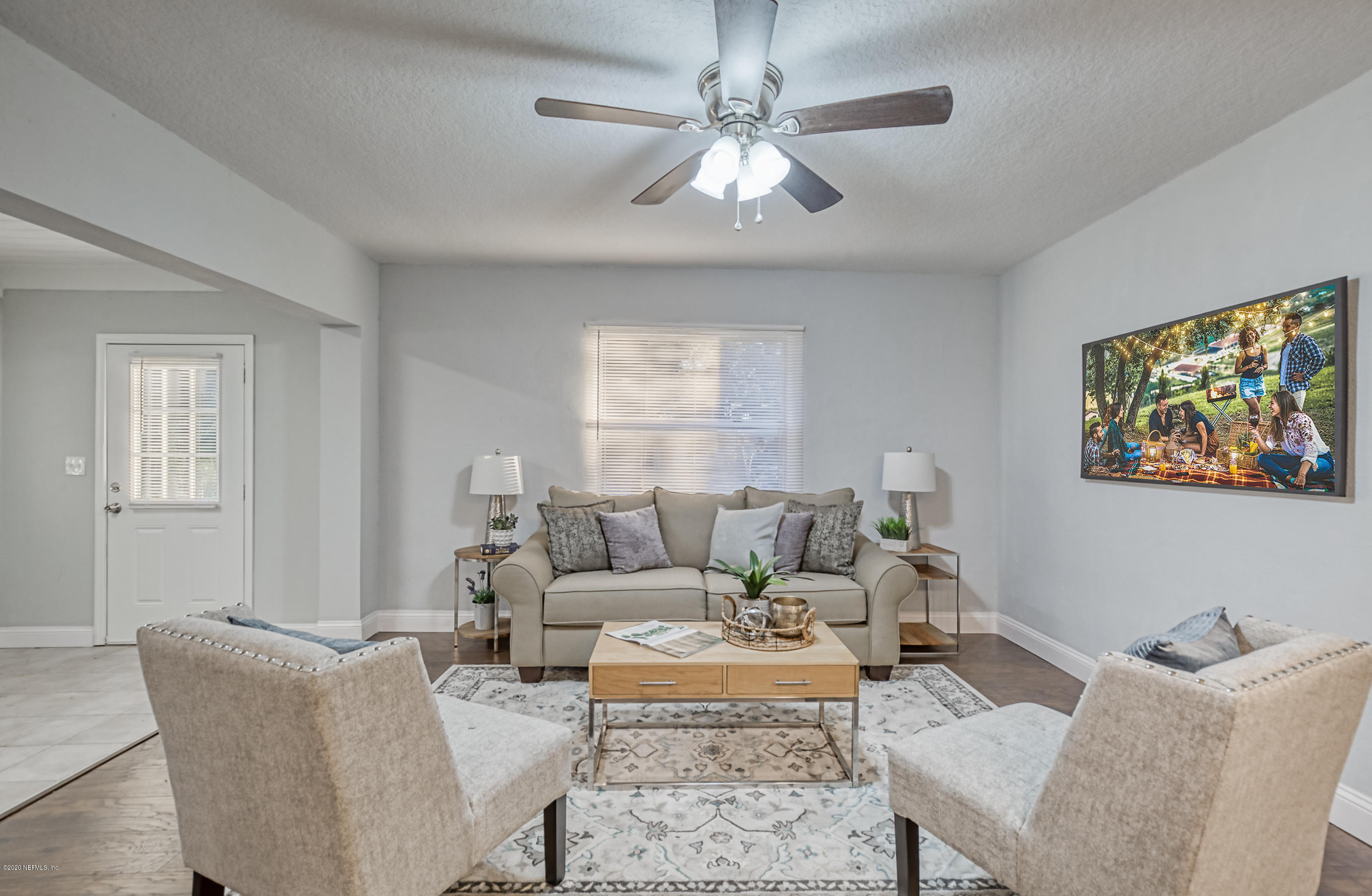 6711 Ryance Road Jacksonville, FL 32211 - Photo 6 of 26 a living room with furniture a chandelier and a window